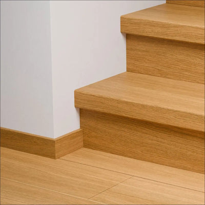 Light oak quick-step capture stair cover with matching baseboard and flooring featuring capture stair covers and stair nosing