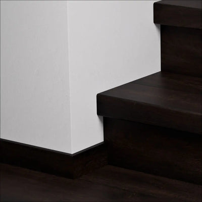 Dark wood quick-step capture stair cover with sleek modern design and clean lines for stylish stair nosing upgrades