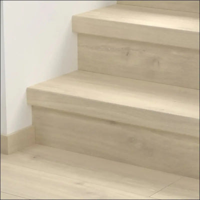 Light-colored quick step classic stair cover with smooth minimalist design for classic laminate flooring stairs
