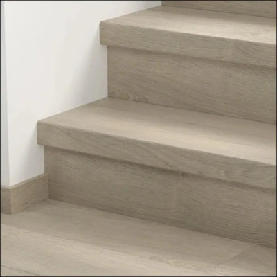 Modern gray concrete stairs featuring quick step classic stair cover with a smooth minimalist design