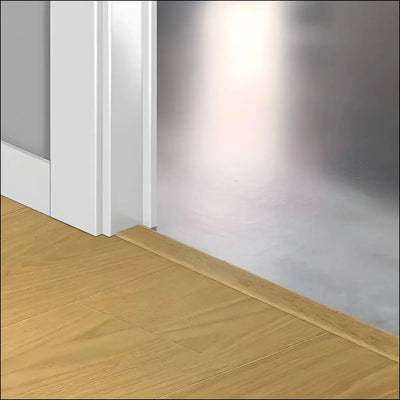 Light-colored wooden baseboard with smooth finish and clean edges in quick-step capture incizo profile style fitting floor and wall
