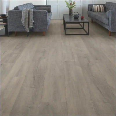Light gray wood-plank laminate flooring with subtle natural grain in quickstep capture patina oak grey design