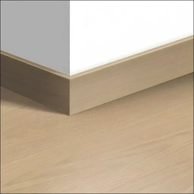 Beige wood-effect quickstep capture skirting board 77mm with smooth matte finish ideal for laminate flooring edges