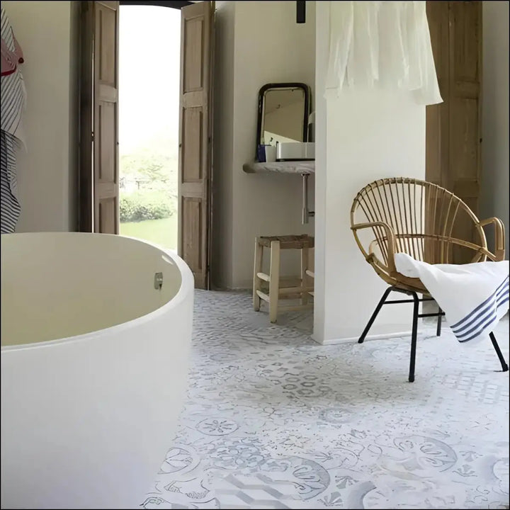 White freestanding bathtub with smooth curved edges on berry alloc ocean laminate flooring retro chic blue grey