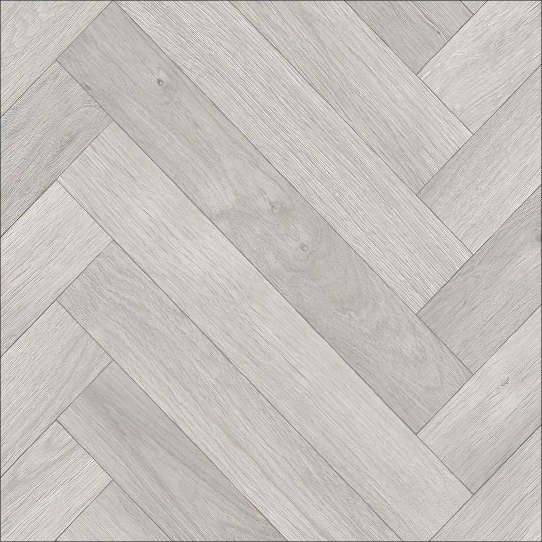 Light gray caspien sheet vinyl flooring with a realistic wood herringbone pattern and a felt backed design