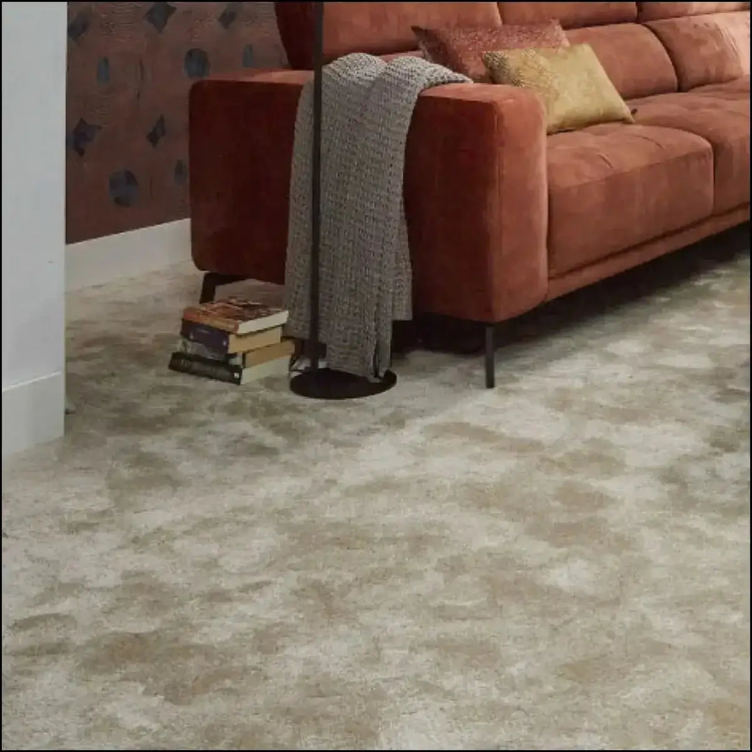 Beige textured decadence soft touch saxony carpet with a subtle mottled pattern offers plush comfort