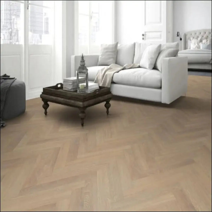Premium 12mm herringbone laminate flooring in light oak sandy oak color with durable wood texture finish