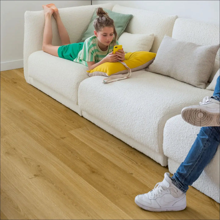 Quick Step Bloom Botanic Smoked Oak Luxury Vinyl Flooring AVMPU40238 with White Sofa