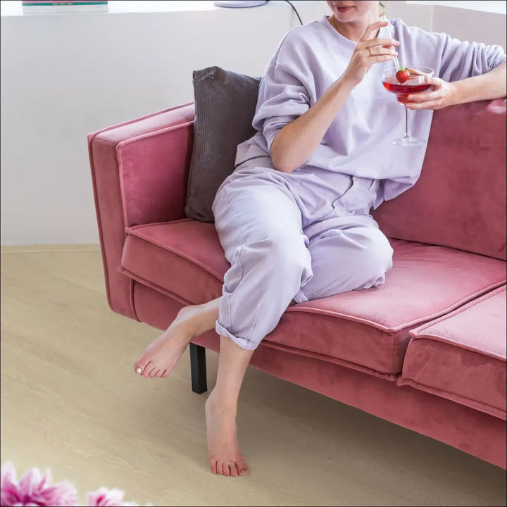 Quick Step Bloom Sea Breeze Oak Beige Luxury Vinyl Flooring AVMPU40080 with Lady on Pink Sofa