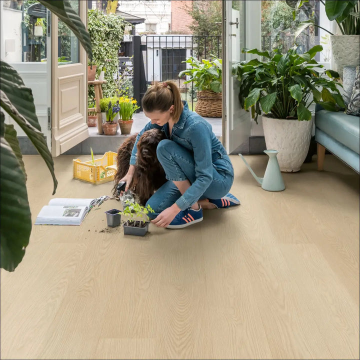 Quick Step Blos Buttermilk Oak Waterproof Luxury Vinyl Flooring | AVSPU40277 with Lady Planting