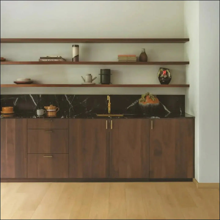 Dark marble countertop with gold faucet and wooden cabinetry featuring quick-step cala leather oak extra matt flooring