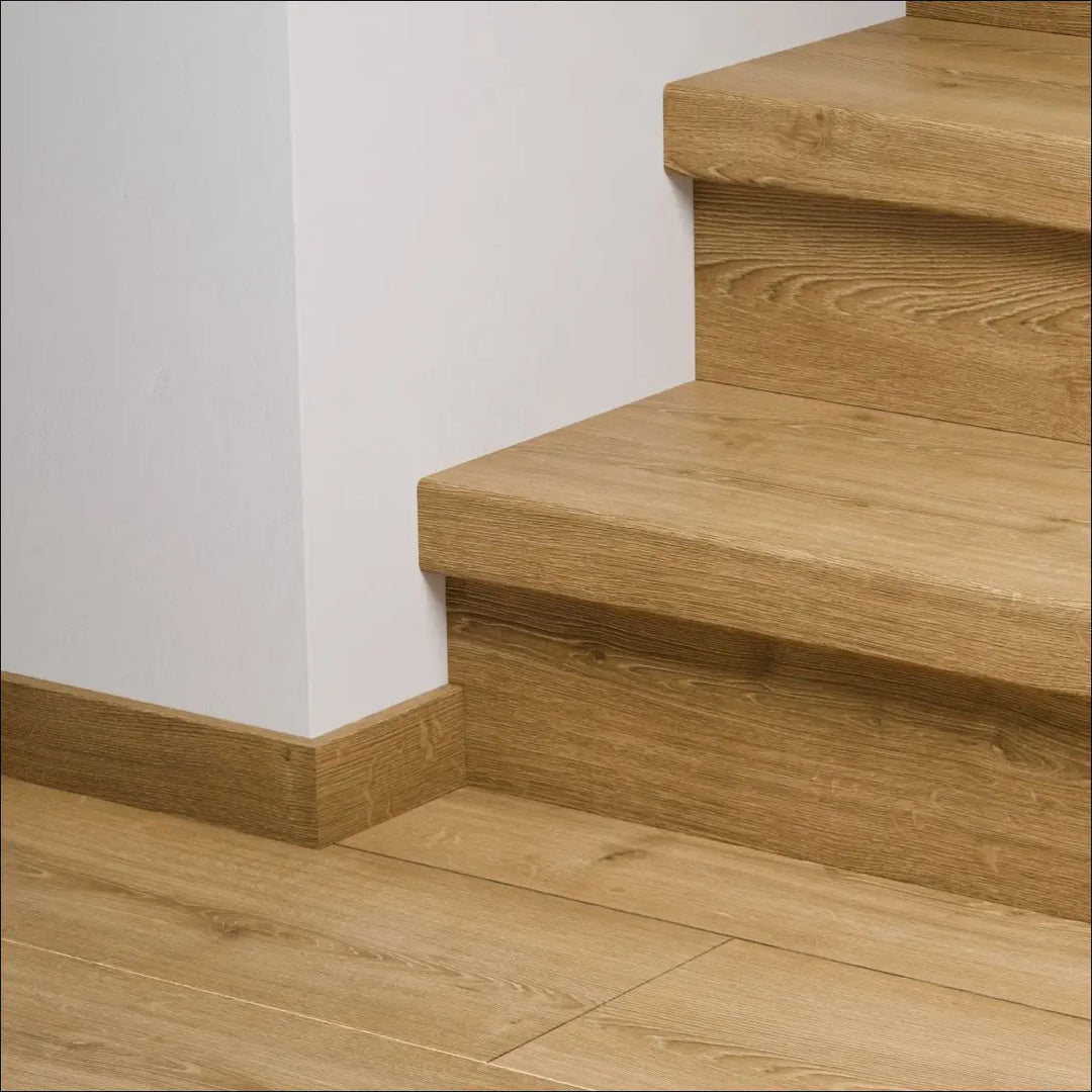 Light oak quick-step capture stair cover with visible grain and matching baseboard for easy stair nosing update