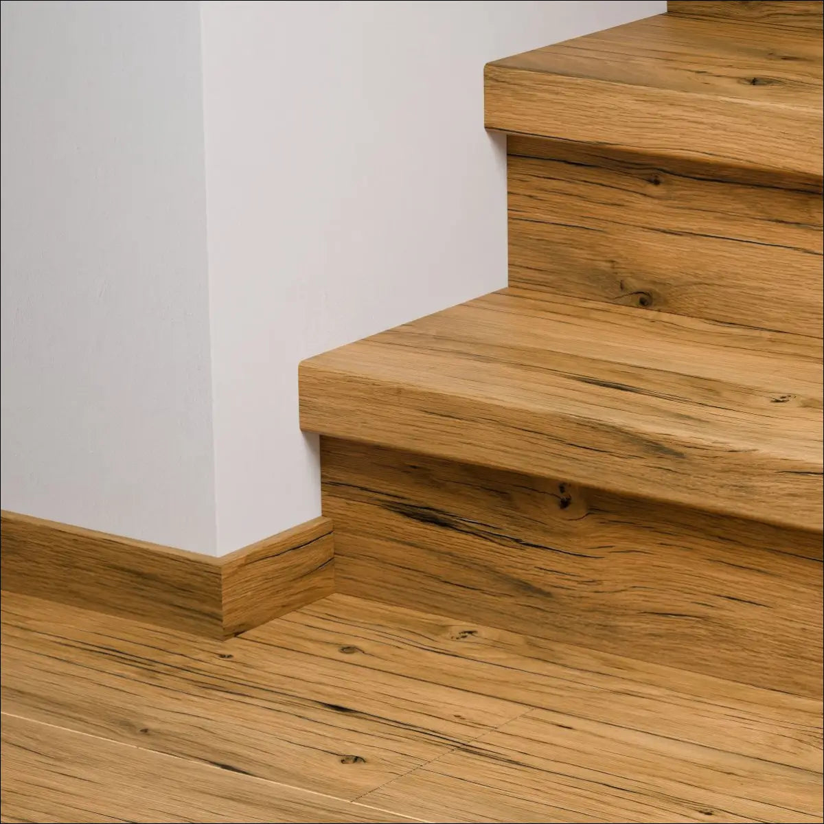 Light brown wooden quick-step capture stair cover showing natural knots and grain for stylish stair nosing use