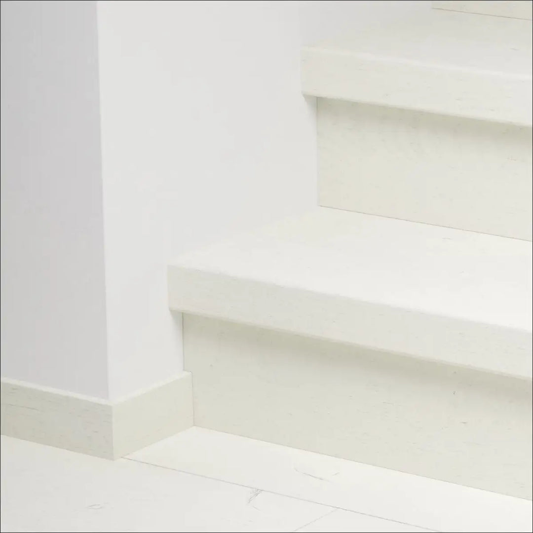 White concrete staircase with minimalist design featuring quick-step capture stair covers and stair nosing for durability