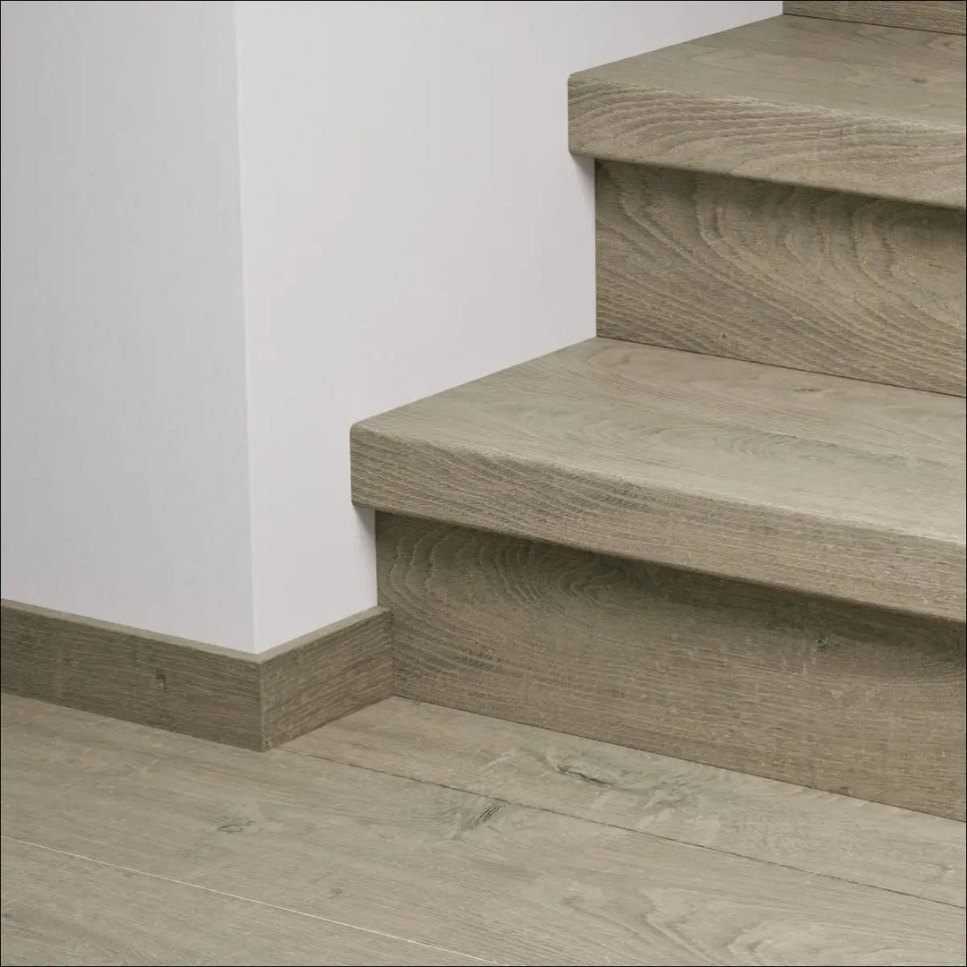 Modern gray wood look quick step capture stair cover with subtle grain texture and clean minimalist design stair nosing