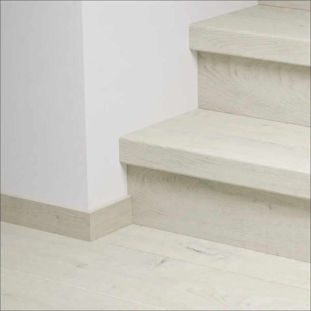 Minimalist off-white concrete quick-step capture stair covers with subtle texture and clean modern stair nosing design