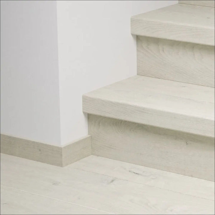 Minimalist off-white concrete quick-step capture stair covers with subtle texture and clean modern stair nosing design