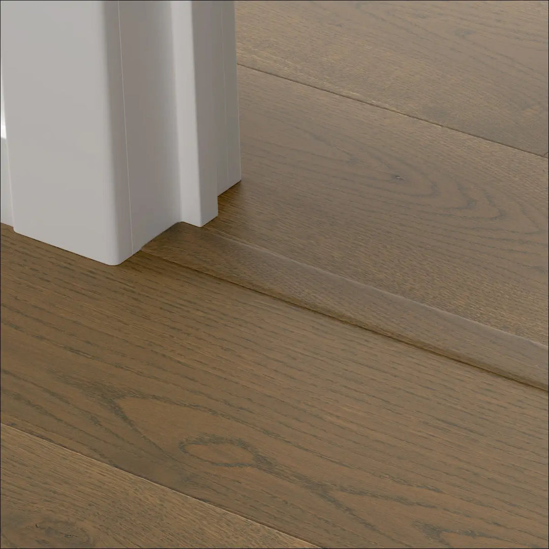 Light brown quick-step cascada incizo profile stair nosing with subtle wood grain and white door threshold