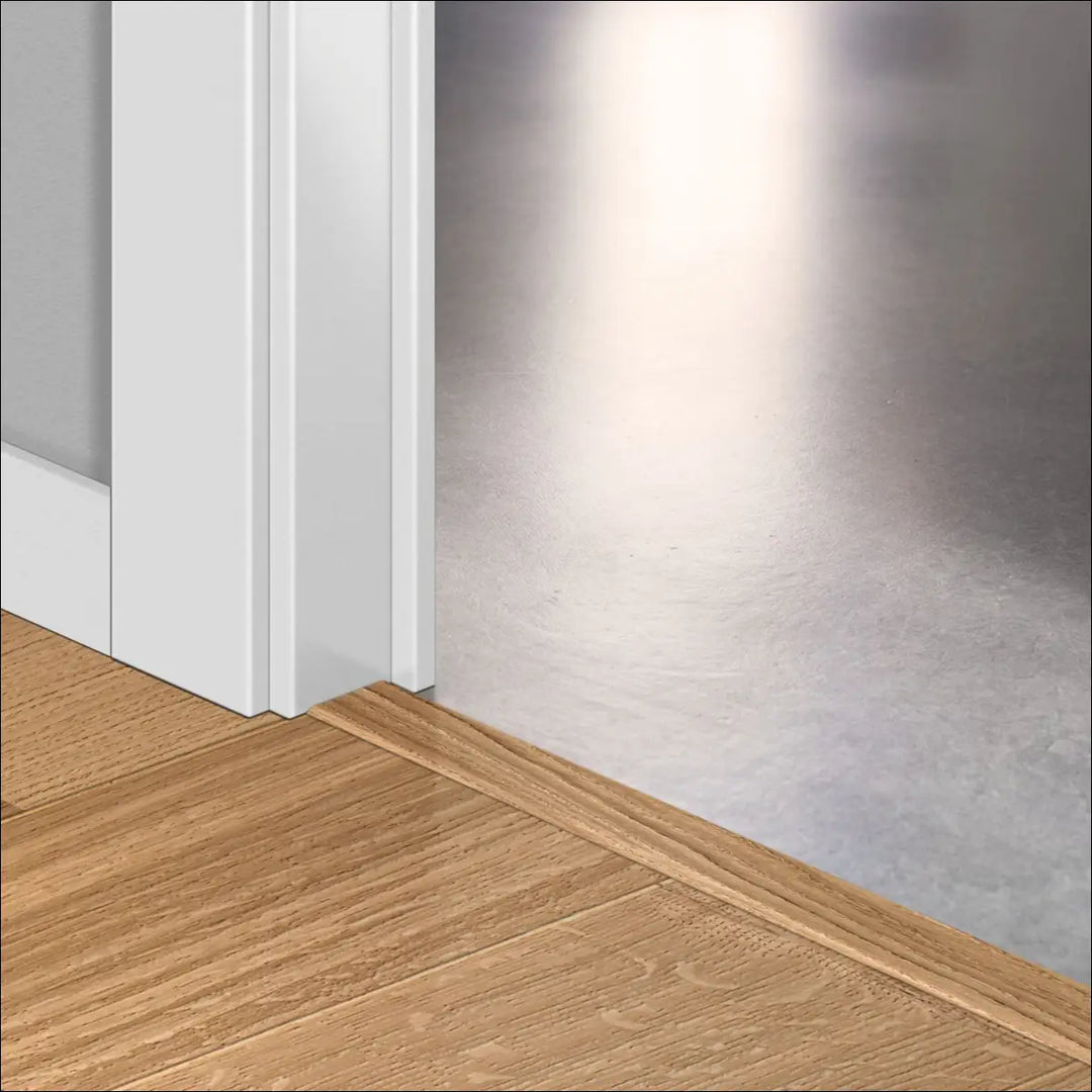 White door threshold with smooth edge using quick step cascada incizo profile for seamless stair nosing transition