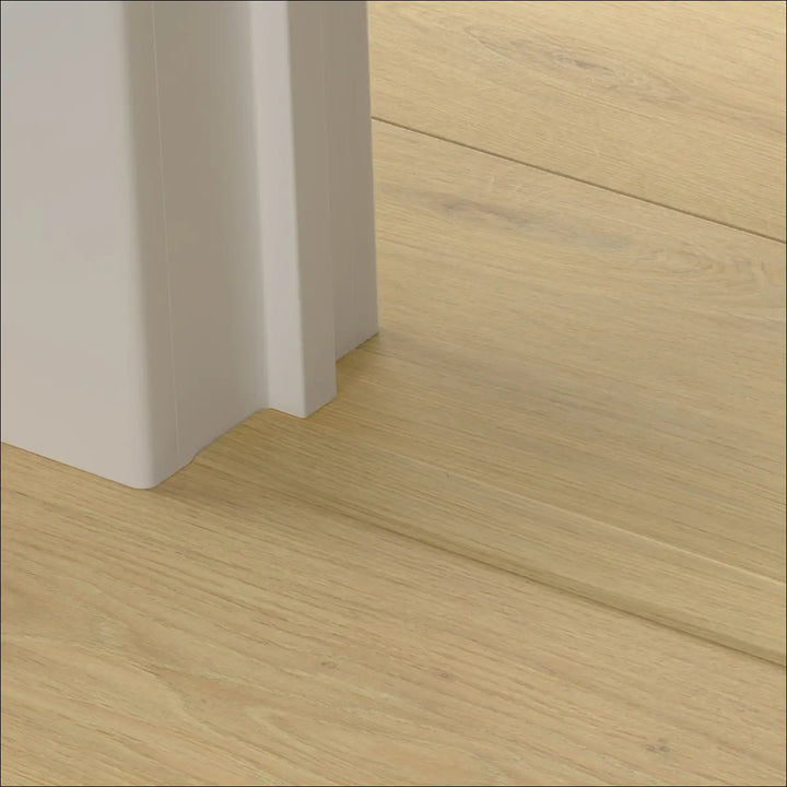 White quick-step cascada incizo stair nosing with smooth minimalist design complements light wood flooring