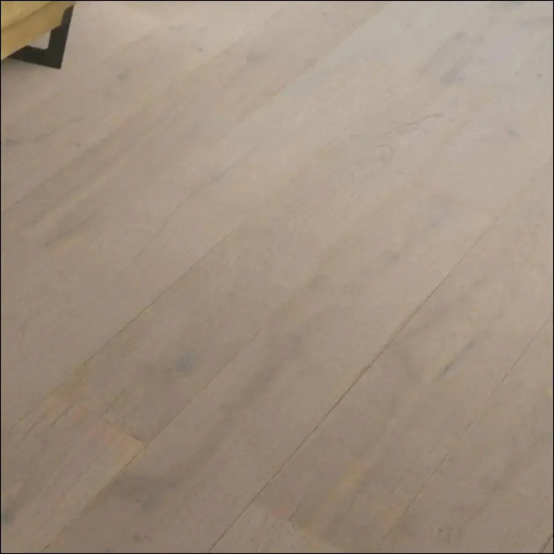 Light-colored quick step cascada wood flooring in cotton grey oak with smooth natural finish and visible grain patterns
