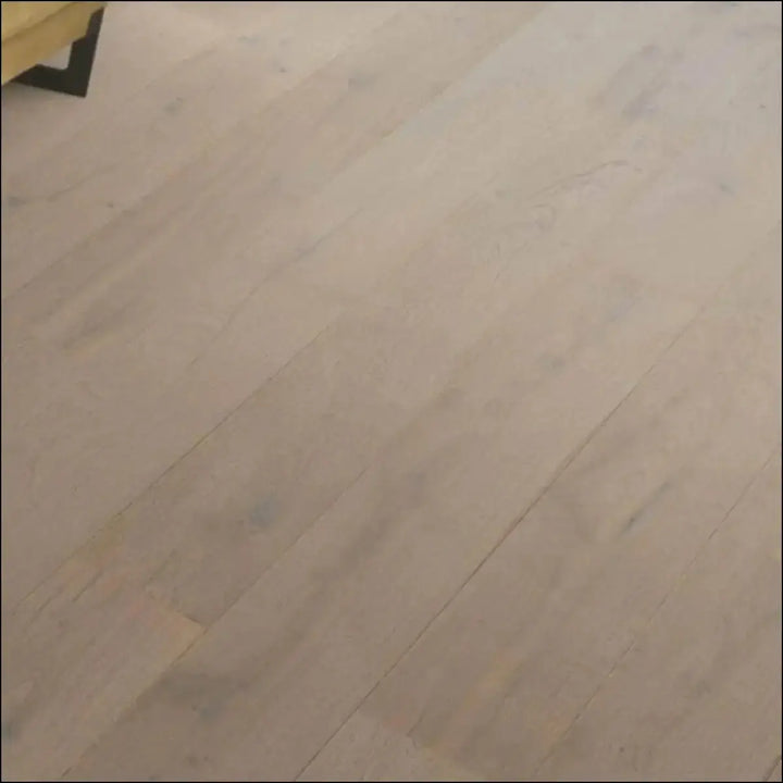 Light-colored quick step cascada wood flooring in cotton grey oak with smooth natural finish and visible grain patterns