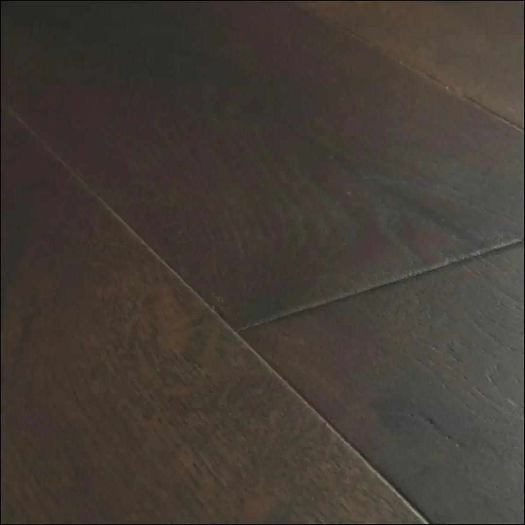 Dark brown hardwood floor planks with a smooth finish from quick step cascada oak extra matt collection
