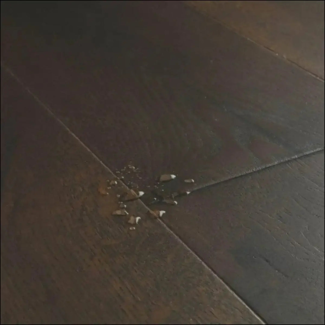 A cluster of shattered glass on quick step cascada wood flooring tobacco oak extra matt dark wooden floor