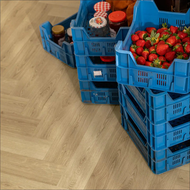 Quick Step Ciro Botanic Beige Herringbone Vinyl Flooring AVHBU40362 Close Up with Crates of Fruit