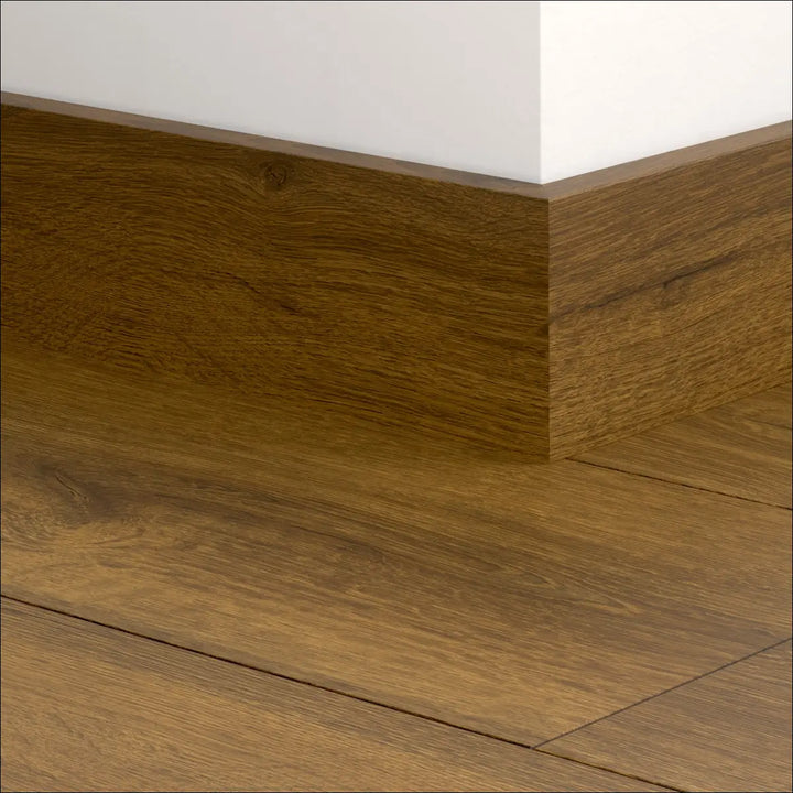 Brown wooden quick-step classic skirting boards 77mm with natural wood grain finish matching quickstep classic flooring