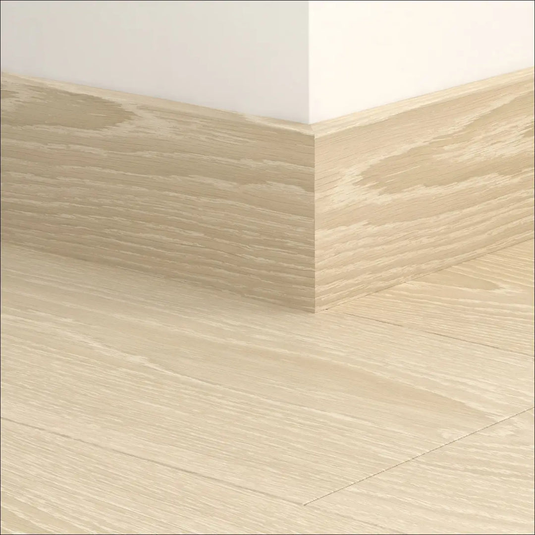 Light oak finish quickstep classic skirting boards with subtle wood grain pattern in 77mm wood effect baseboard