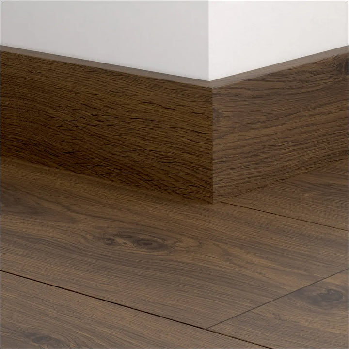 Dark brown wooden quickstep classic skirting boards 77mm with natural wood grain finish matching quickstep classic flooring