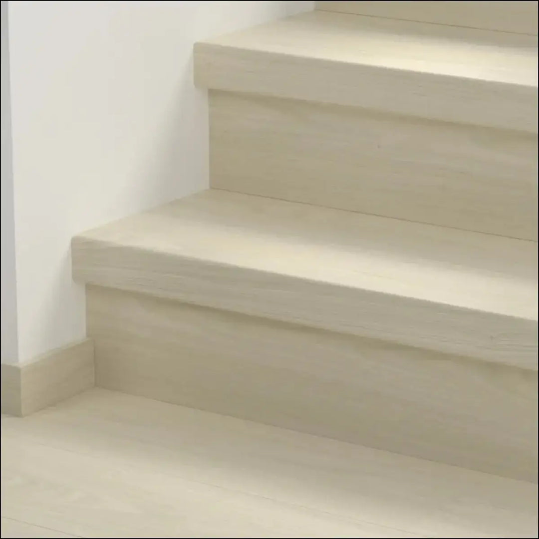 Beige wooden staircase with clean minimalist design featuring quick step classic stair cover in classic laminate flooring