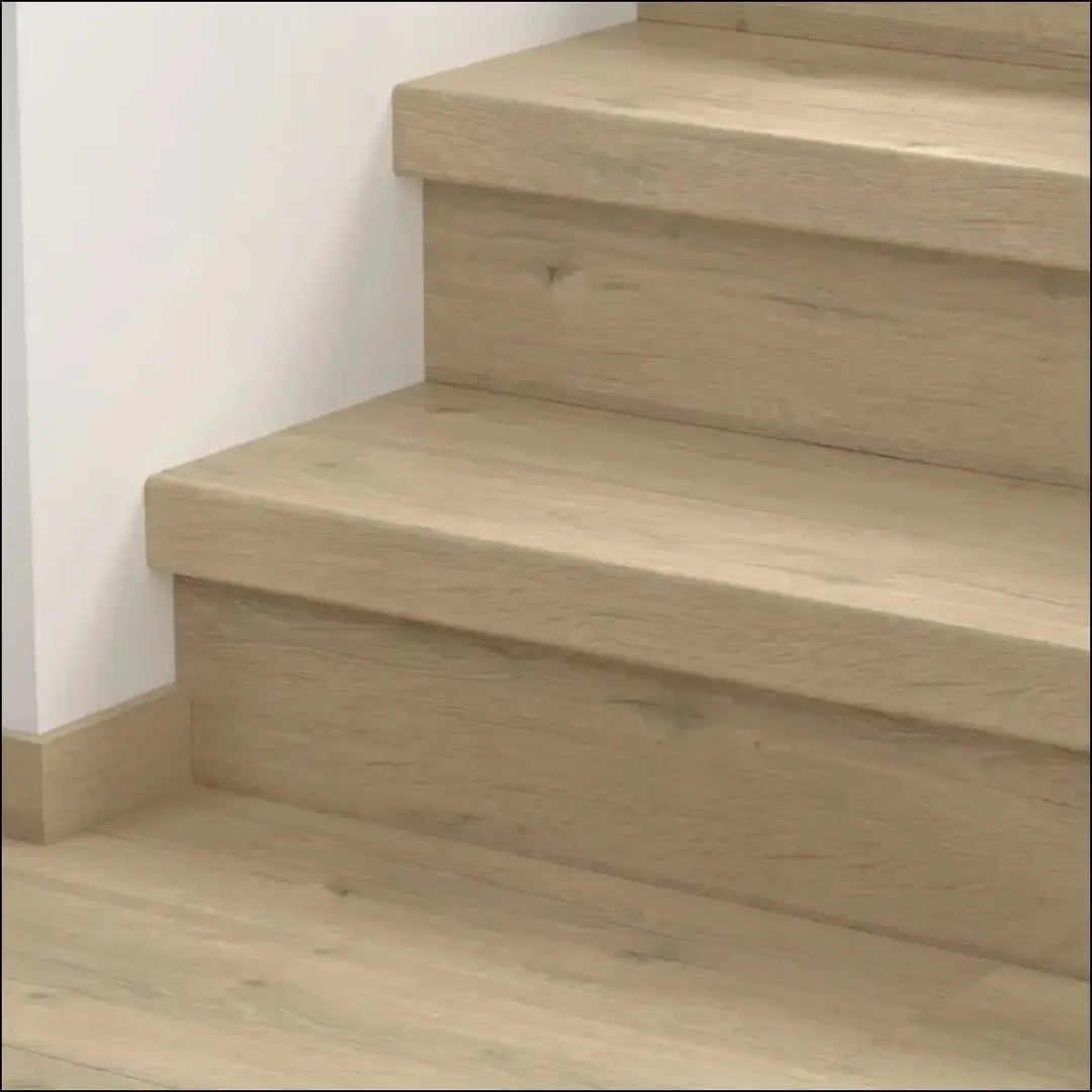 Light-colored wooden quick step classic stair cover with smooth natural finish and visible grain patterns