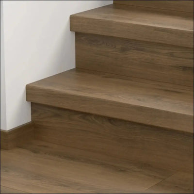 Modern floating wooden staircase featuring quick step classic stair cover with warm natural finish and subtle grain texture