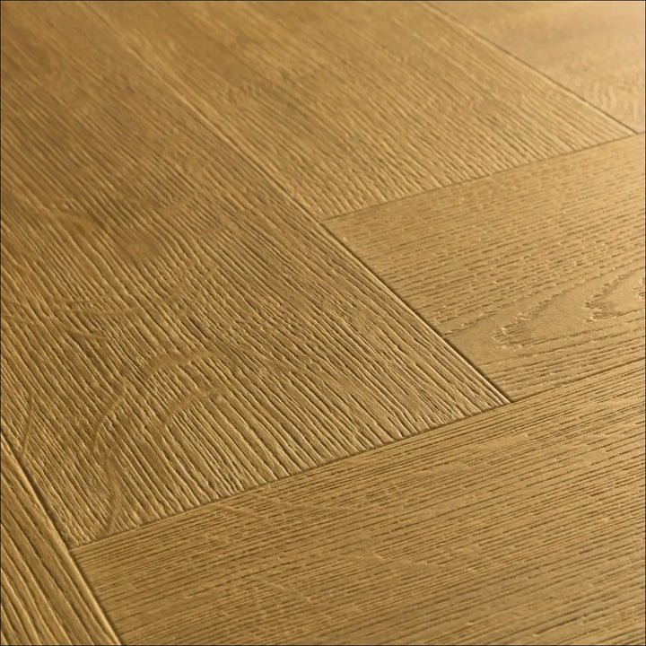 Light brown quick step impressive herringbone laminate flooring with scratch guard in cinnamon oak wood grain pattern
