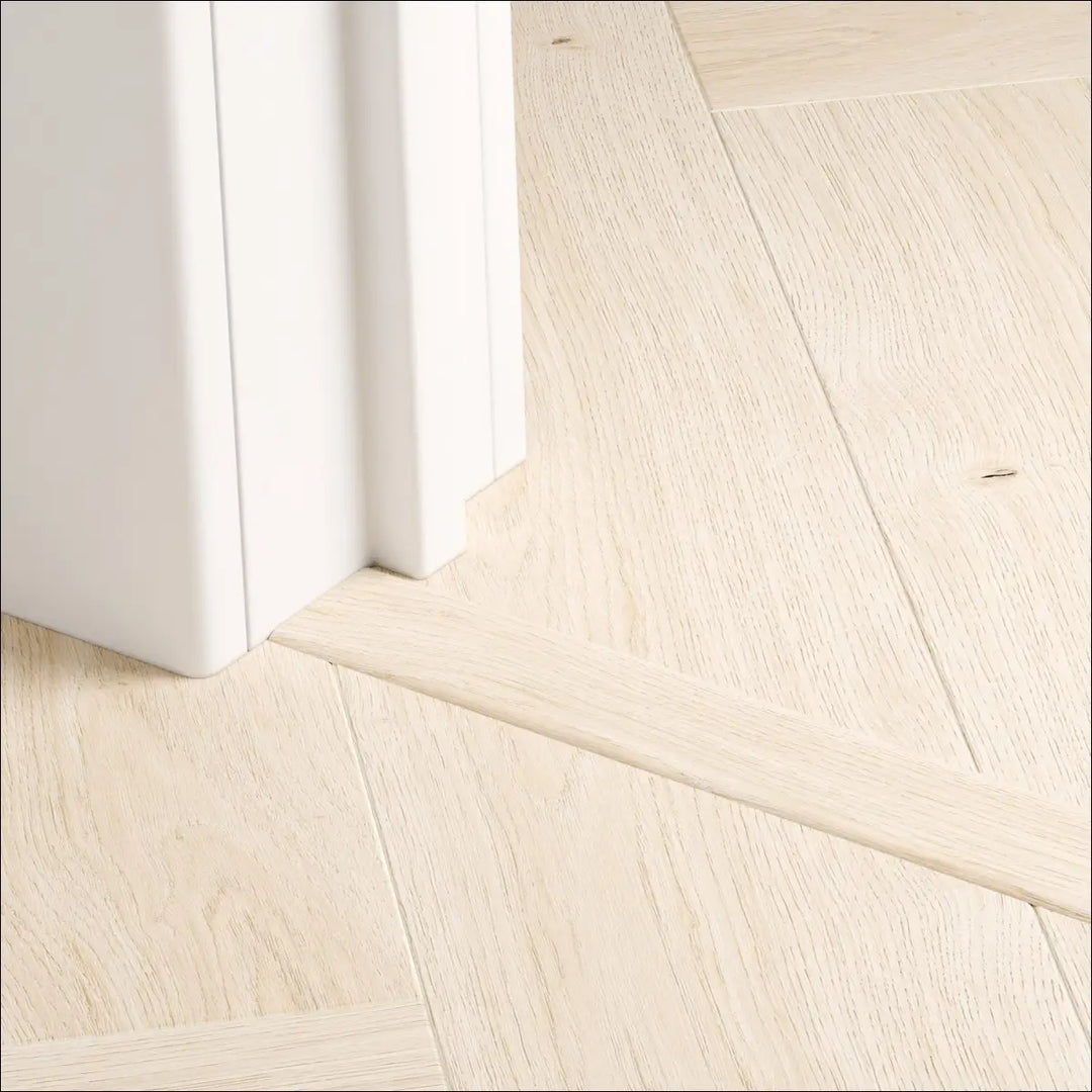 Beige wood-grain floor trim with a natural finish from quick step impressive design incizo profile perfect for herringbone floors