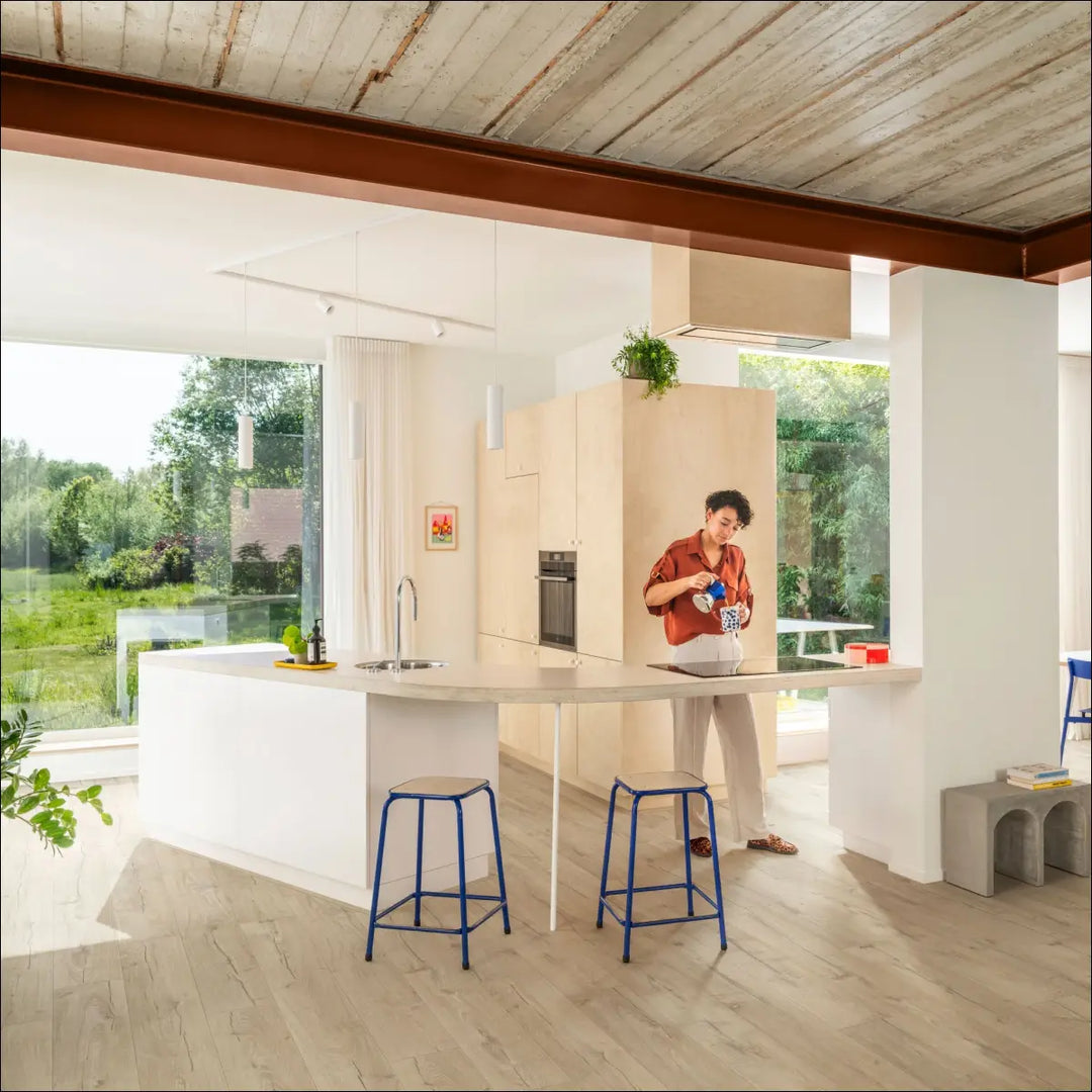 Light-colored oak beige laminate flooring in open plan kitchen by quick step impressive classic oak beige interior