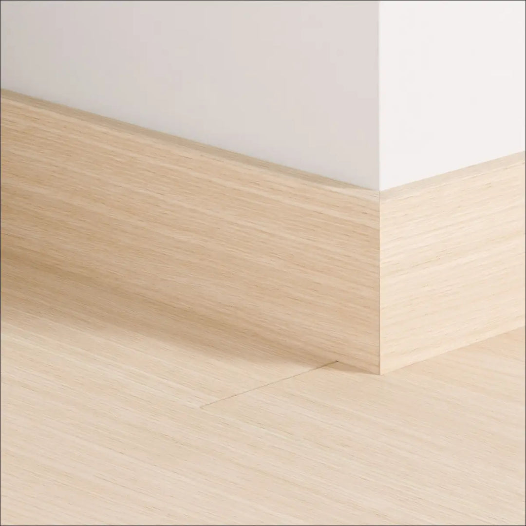 Light oak quickstep impressive 77mm skirting board with smooth natural wood grain finish for stylish wall edges