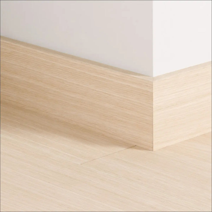 Light oak quickstep impressive 77mm skirting board with smooth natural wood grain finish for stylish wall edges