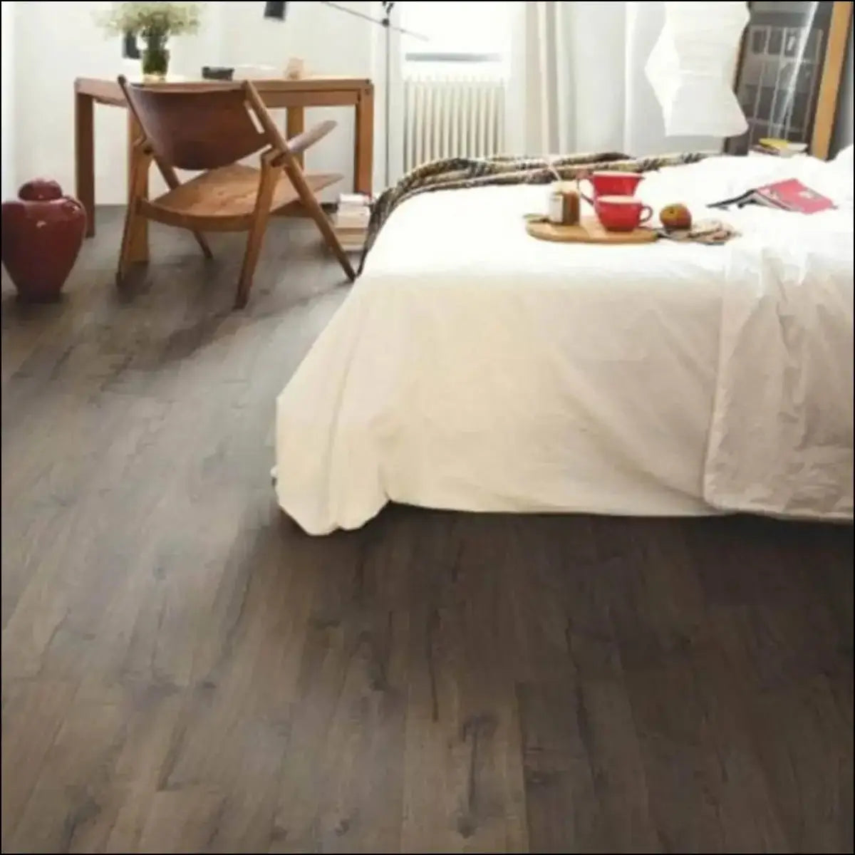 Dark gray wood-plank flooring with natural grain pattern in quick step impressive ultra laminate classic oak brown