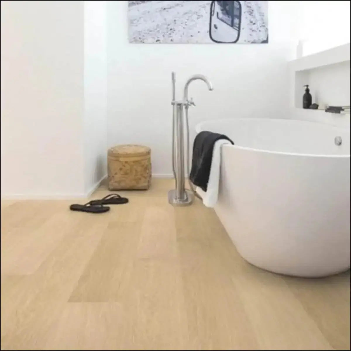 White freestanding bathtub with sleek modern design and chrome faucet on quick step impressive ultra white varnished oak floor