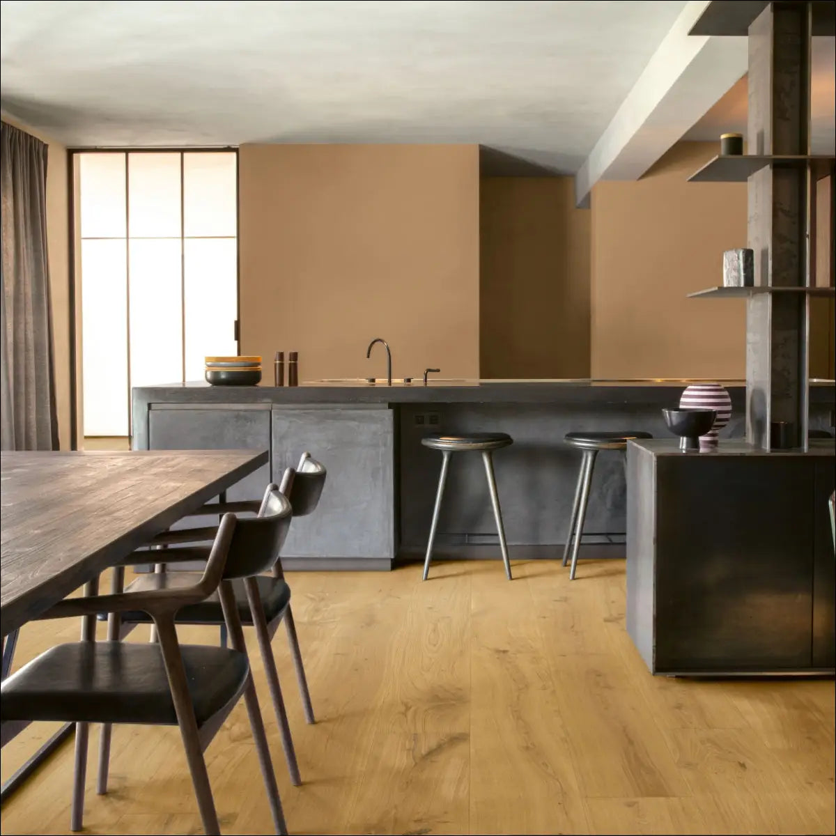 Modern minimalist kitchen with quick-step massimo cappuccino blonde oak floors and concrete countertops with dark wood table