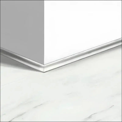 Silver metallic quick step oro vinyl scotia baseboard trim along white wall and marble floor for luxury vinyl floors