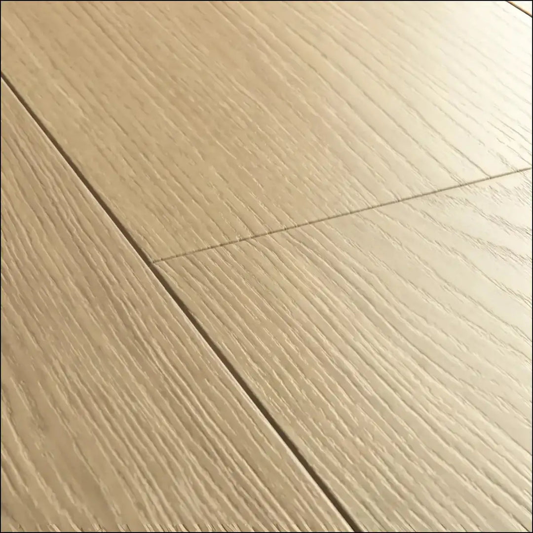 Light beige hardwood floor planks with natural grain pattern in quickstep capture laminate beige varnished oak