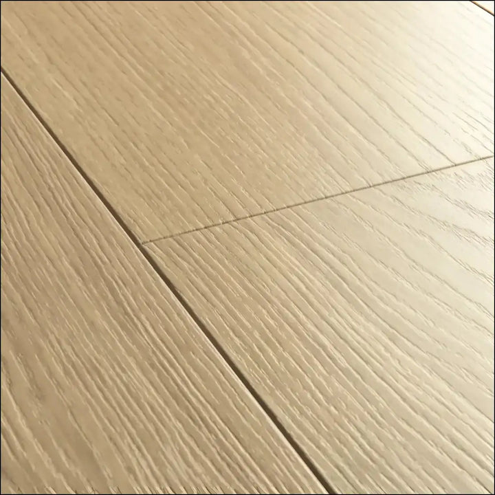 Light beige hardwood floor planks with natural grain pattern in quickstep capture laminate beige varnished oak