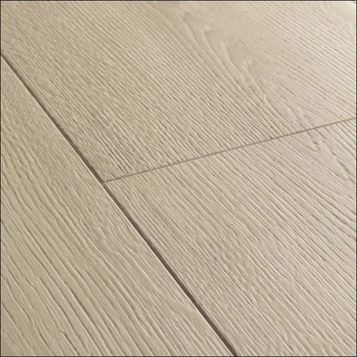 Beige wood-grain laminate flooring with subtle texture and clean lines in quickstep capture brushed oak beige finish