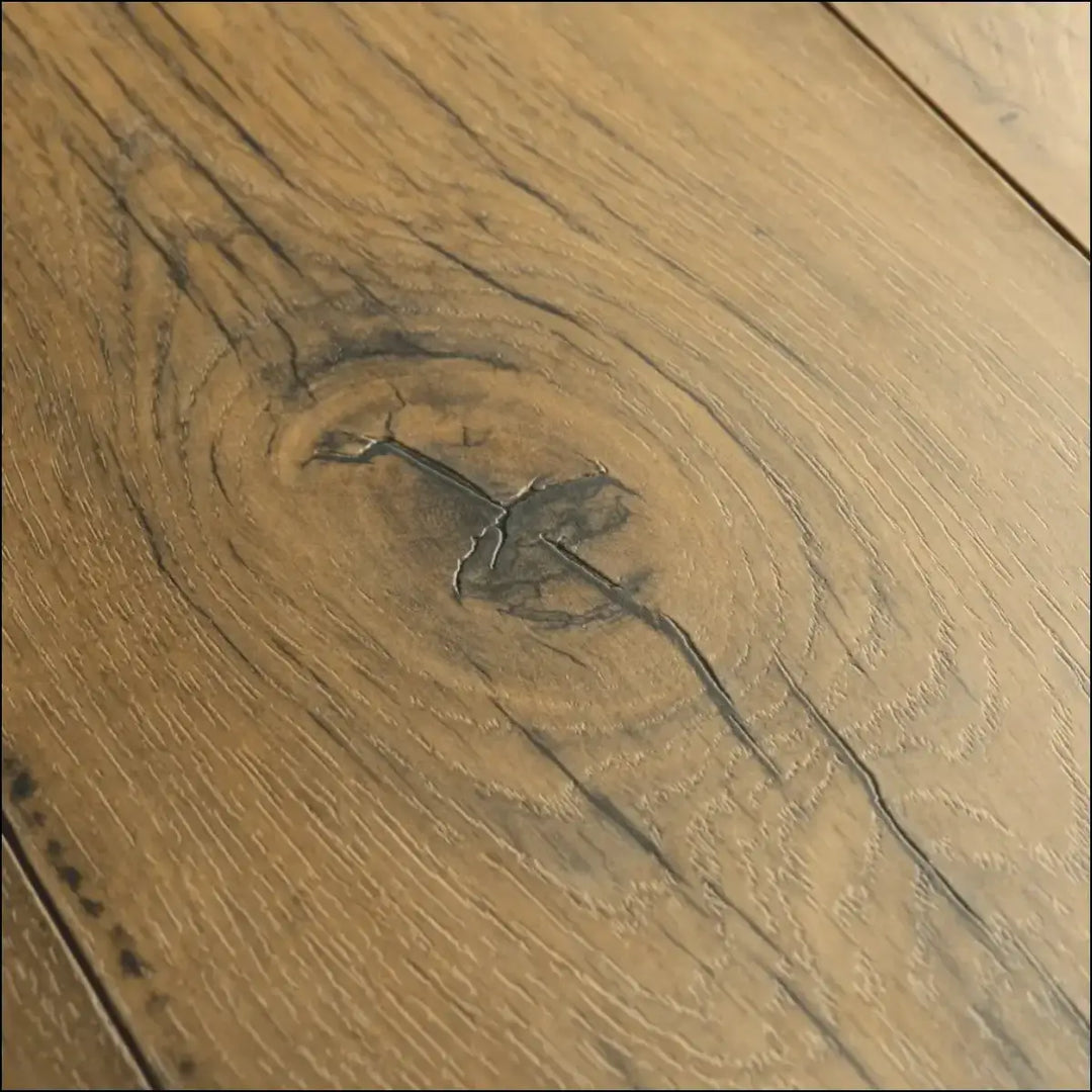A close-up of quick-step capture laminate cracked oak natural wood floor plank with visible grain and dark staining