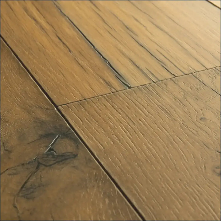 Light brown quickstep capture laminate cracked oak natural floor planks with visible wood grain and dark knots