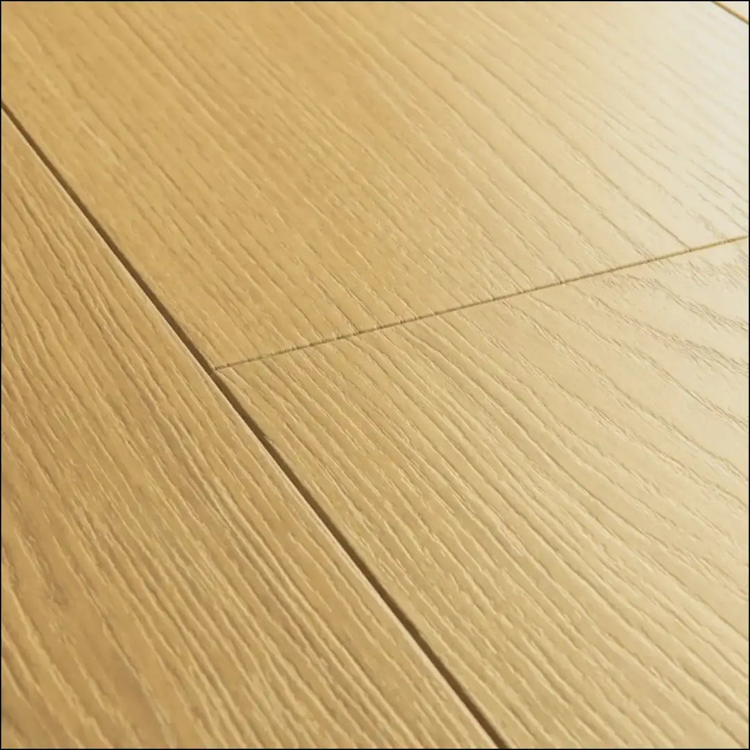 Quickstep capture light oak laminate floor planks with natural varnished oak grain pattern for stylish interiors